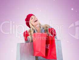 Blonde in winter clothes with shopping bags