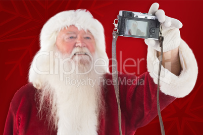 Composite image of santa claus makes a selfie