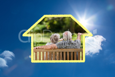 Composite image of couple sitting on the bench with their back t