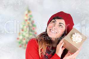 Composite image of brunette in hat listening a gift