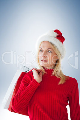 Composite image of happy festive blonde with shopping bags