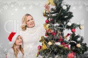 Composite image of festive mother and daughter decorating christ