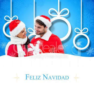 Composite image of festive young couple holding gift