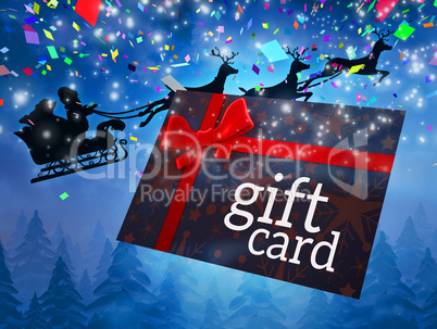 Composite image of santa flying his sleigh behind gift card