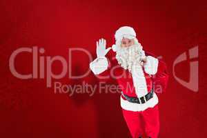 Composite image of santa holding a sack and waving