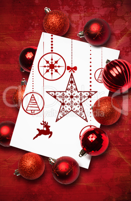 Composite image of hanging red christmas decorations