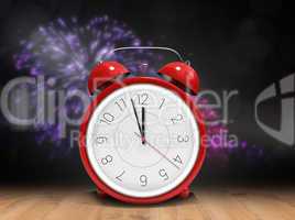 Composite image of alarm clock counting down to twelve