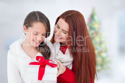 Composite image of mother and daughter with gift