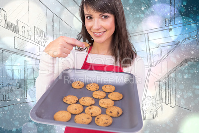 Composite image of festive brunette showing hot cookies