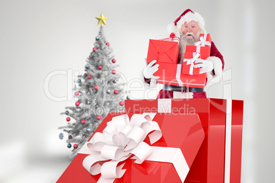 Composite image of santa standing in large gift