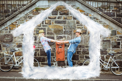 Composite image of hip young couple dancing by brick wall with t