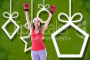 Composite image of festive brunette in boxing gloves cheering