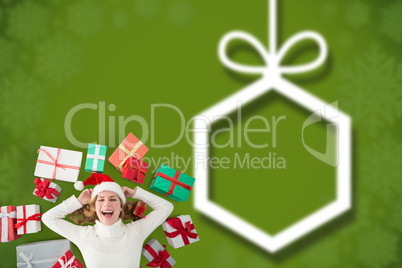 Composite image of woman laying on the floor with gifts around h