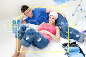 Composite image of young couple relaxing after painting a room i