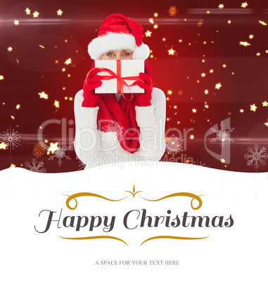 Composite image of festive woman holding gift