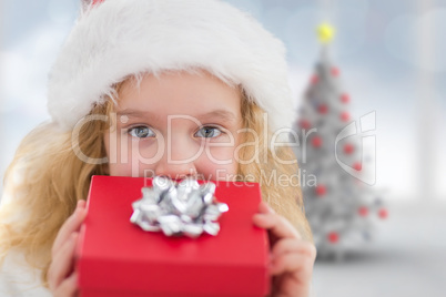 Composite image of cute girl with gift