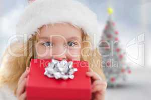 Composite image of cute girl with gift