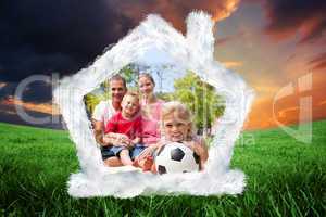 Composite image of little blond girl holding a soccer ball at a