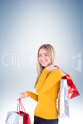 Stylish blonde smiling with shopping bags