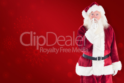 Composite image of santa asking for quiet to camera