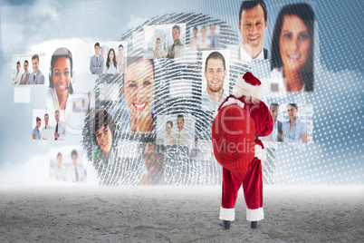 Composite image of santa carrying sack of gifts