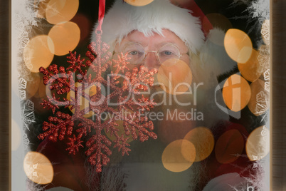 Composite image of santa smiles with folded arms