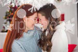 Composite image of festive mother and daughter on the couch