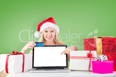 Composite image of woman pointing to laptop screen