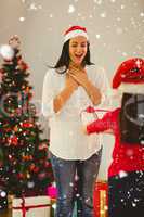Composite image of daughter surprising her mother with christmas gift