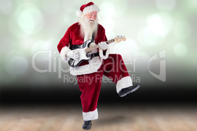 Composite image of santa claus has fun with a guitar