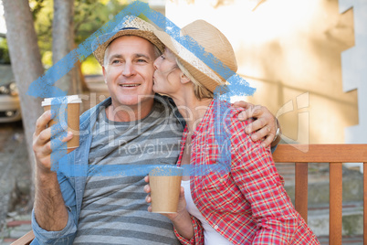 Composite image of happy mature couple drinking coffee on a benc