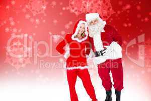 Composite image of santa and mrs claus smiling at camera