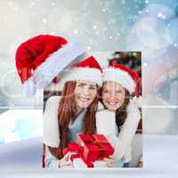 Composite image of festive mother and daughter smiling at camera