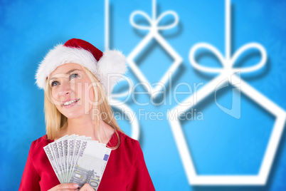 Composite image of festive blonde in red dress holding her cash