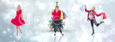 Composite image of happy blonde holding shopping bags