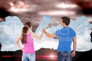 Composite image of couple painting together