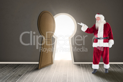 Composite image of santa shows something to camera