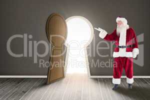 Composite image of santa shows something to camera