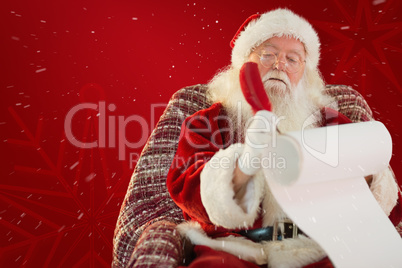 Composite image of father christmas writing list with a quill