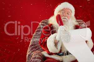 Composite image of father christmas writing list with a quill