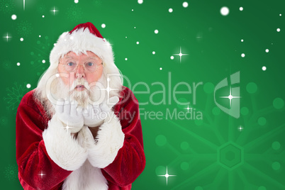 Composite image of santa claus blows something away