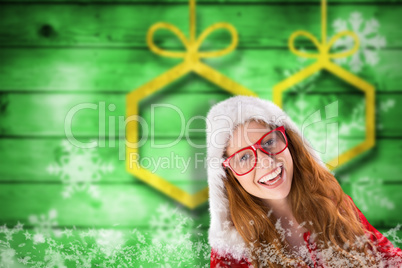 Composite image of festive redhead smiling at camera