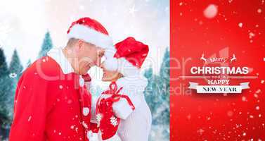 Composite image of festive mature couple holding gift