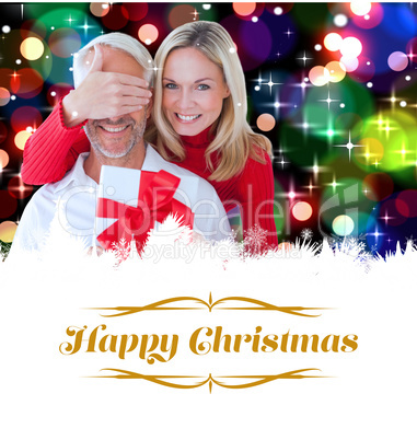 Composite image of loving couple with gift