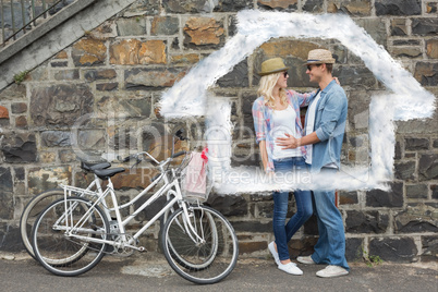 Composite image of hip young couple hugging by brick wall with t