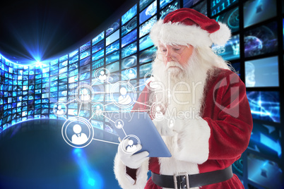 Composite image of santa uses a tablet pc