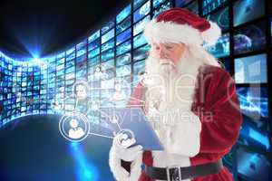 Composite image of santa uses a tablet pc