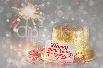 Happy new year card leaning on gold party hat
