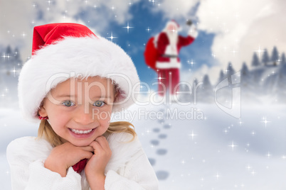 Composite image of cute little girl wearing santa hat