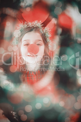 Composite image of festive little girl wearing red nose